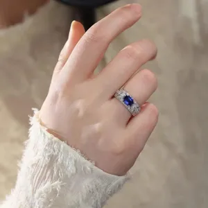 Elegant blue sapphire ring for women with double prong setting and sparkling pave rhinestones.