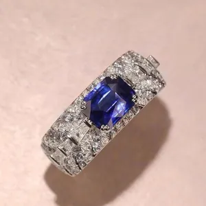 Wide band sapphire ring with pave diamonds, emerald cut blue stone luxury jewelry