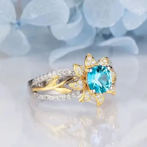Detailed close-up of the sunflower simulated sapphire ring featuring sparkling micro-pave cubic zirconia.