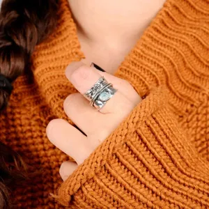 Vintage antique silver spinner ring with blue stone and leaf carved band detail close-up