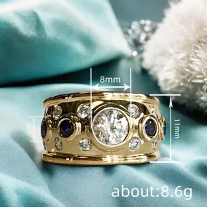 Vintage wide gold ring with bezel set cubic zirconia and blue sapphire stones for women.