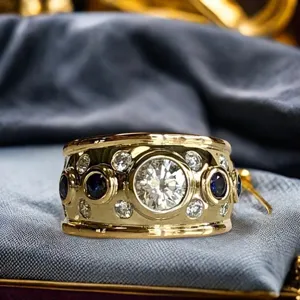 Detail shot of a wide gold ring featuring a sparkling central diamond and sapphire stones.