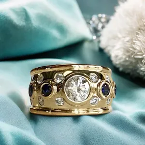 Exquisite vintage wide gold ring with dazzling central zircon and blue stone detail.