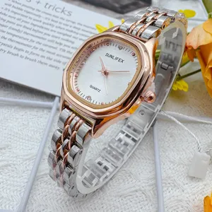 Exquisite small square dial quartz watch for women with two-tone metal bracelet strap detailing.