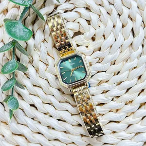 Elegant women gold quartz watch with green octagonal dial steel strap detail view