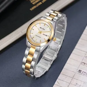 DINUO quartz watch detail view, silver and gold tone stainless steel strap with date display.