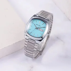 Stainless steel women watch detail, light blue dial with day date window and metal strap.