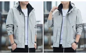 Men's outdoor hooded jacket close-up, showing zipper pocket and contrast lining details.