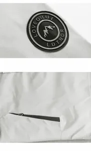 Detailed view of the casual jacket showcasing sleeve badge embroidery and zipper pocket.