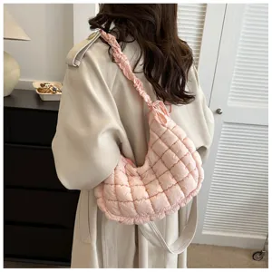 Pink quilted shoulder bag detail showcasing soft puffer cloud design and scrunchie strap style.
