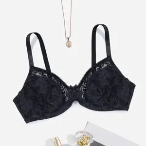 Close-up detail of black lace full-cup bra featuring delicate straps and bow accent.