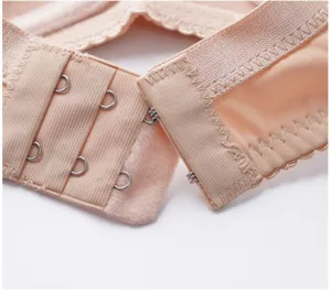 Close-up detail of nude color bra back closure hook and eye smooth comfortable underwear