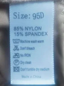 Detailed view of plus size bra care label showing size 95D, nylon and spandex material details.