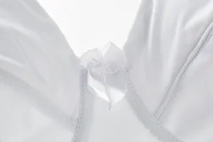 Detailed close-up view of white plus size smooth bra featuring cute center bow accent.