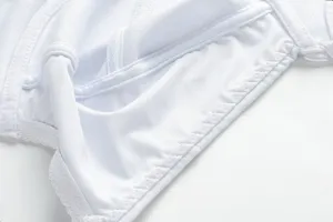White bra inner cup detail view, showing breathable fabric and fine stitching craftsmanship.