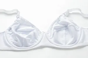 Detailed view of white underwire bra cup texture, smooth fabric and soft strap close up
