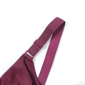 Close-up detail of adjustable wide bra strap and ring in elegant wine red color texture.