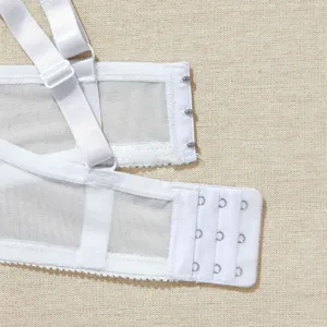 Detailed view of women's white bra back closure with adjustable straps and hook-and-eye.