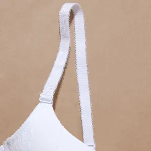 Close-up detail of white lace bra strap and adjustable buckle, soft and comfortable.