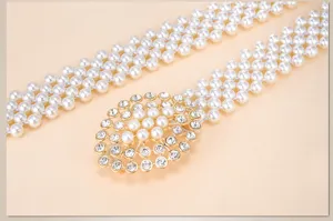 Close-up detail of multi-layer pearl belt featuring sparkling rhinestone gold alloy buckle.