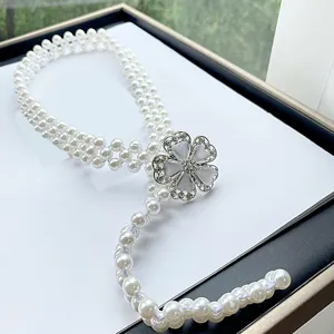 Elegant multi-strand faux pearl waist chain with sparkling rhinestone flower buckle for dresses.