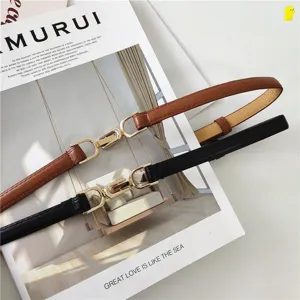 Adjustable thin leather belt detail, classic black and brown straps with gold buckle.