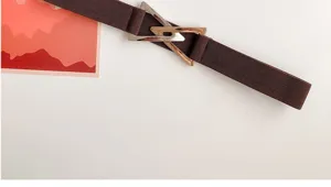Coffee brown elastic waist belt featuring a striking metallic geometric triangle buckle design.