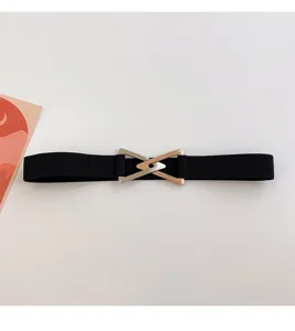 Detail view of a black elastic waist belt with a stylish interlocking metal triangle buckle.