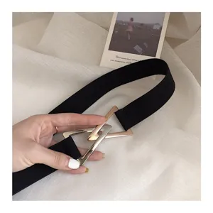 Women elastic belt with triangular metal buckle, minimalist black waist-cinching dress accessory.