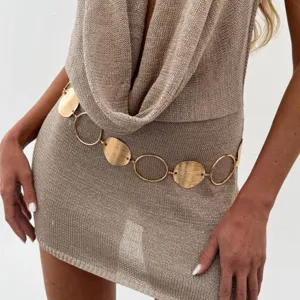 Gold metal chain belt detail close-up, stylish round disc link accessory for dresses.