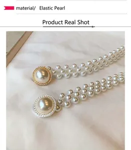Exquisite detail of rhinestone pearl waist chain with elastic beaded design for dress styling.