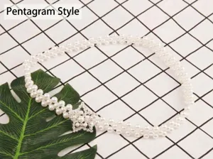 Pearl waist chain detail showing double-strand pearls and a rhinestone star buckle.