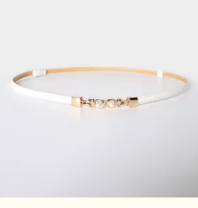 Detailed close-up view of the white thin leather belt featuring a delicate gold metal pearl buckle.