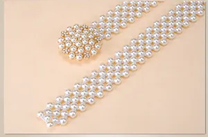 Pearl elastic belt detail view featuring a rhinestone buckle and multi-row beaded strap.