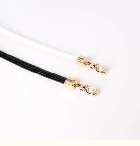 Slim PU leather waist belt for women with stylish pearl and gold metal decoration.