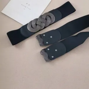 Women's vintage elastic wide belt with ornate metal buckle, black waist cincher for dresses.