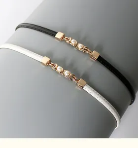 Women thin PU leather dress belt with chic gold chain and pearl detail, elegant waist accessory.