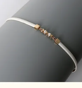 White thin dress belt featuring a delicate gold metal and pearl buckle detail for daily wear.