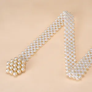 Elegant pearl waist belt for women, elastic beaded dress waistband with stylish clasp accent.