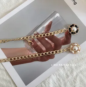 Elegant metal waist chain detail featuring camellia and pearl for women dress and coat.