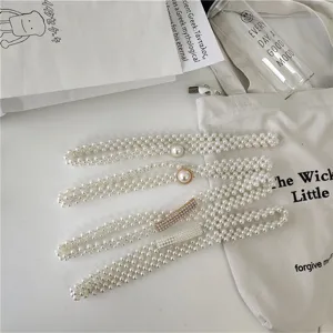 Detailed view of stylish women's pearl waist chain with elastic bead design, elegant dress belt.