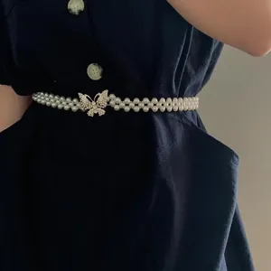 Elastic pearl waist chain with crystal butterfly buckle, elegant slimming belt for dresses.
