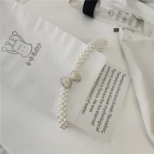 Chic pearl beaded waist chain with rhinestone bow, elegant Korean style dress accessory.