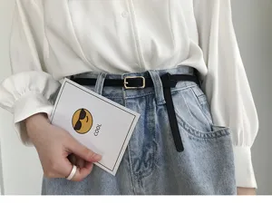 Minimalist women thin belt detail showing gold buckle and sleek leather design for daily wear.
