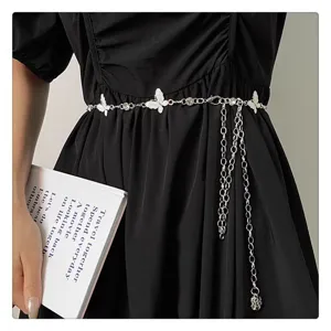 Detailed close-up of silver butterfly waist chain with sparkling rhinestones and tassels.
