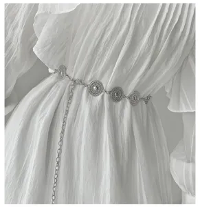 Metal chain belt detail shot, delicate round coin charms, stylish accessory for dresses.