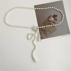 Chic pearl waist chain for women, vintage crystal floral buckle detail for dresses.