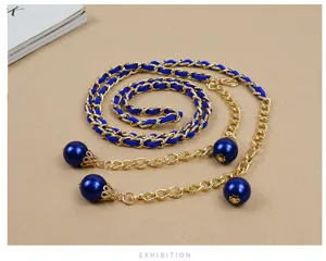 Women fashion waist chain with blue woven leather gold metal chain and elegant pearl pendants.