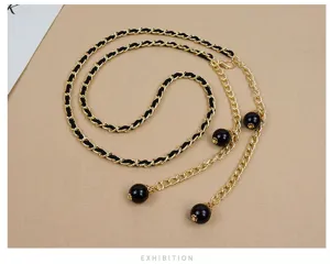 Fashion women metal waist chain with black woven detail and pearl pendant for dress styling.