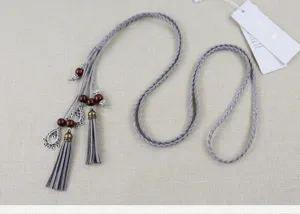 Handmade braided waist belt with wooden beads and tassels, stylish dress accessory.